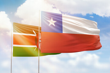 Sunny blue sky and flags of chile and kenya