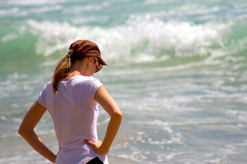 Blonde Woman in Cap at Beach Looking Down