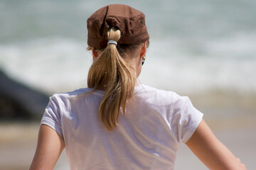 Blonde Woman Wearing Cap and Ponytail at Beach Isolated 
