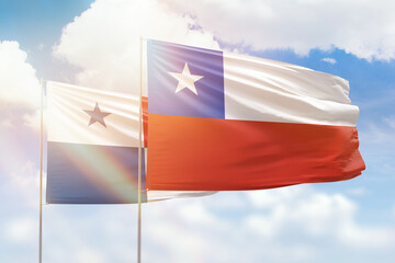 Sunny blue sky and flags of chile and panama