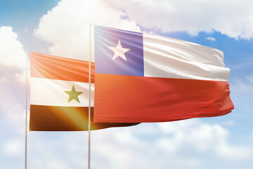 Sunny blue sky and flags of chile and syria