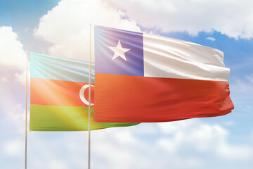 Sunny blue sky and flags of chile and azerbaijan