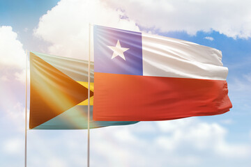Sunny blue sky and flags of chile and bahamas