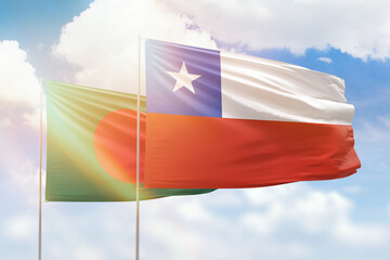 Sunny blue sky and flags of chile and bangladesh