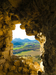 Interior window of the ruins of castle of Queen Jeanne (also called castellas of Roquemartine) near Eyguieres in Provence in France, this window offers a view of a beautiful landscape of the Alpilles 