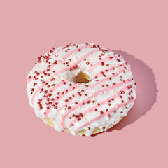 pink donut with glaze on pink pastel background