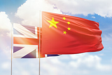 Sunny blue sky and flags of china and great britain