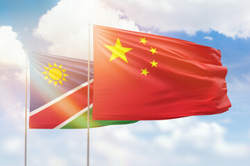 Sunny blue sky and flags of china and namibia