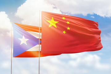 Sunny blue sky and flags of china and puerto rico