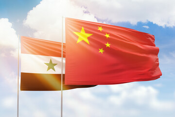 Sunny blue sky and flags of china and syria