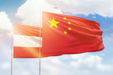 Sunny blue sky and flags of china and austria