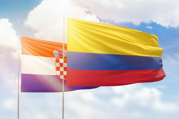 Sunny blue sky and flags of colombia and croatia