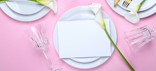 Beautiful table setting with calla lilies on pink background, top view