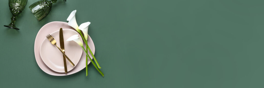 Beautiful table setting with calla lilies on green background. Banner for design