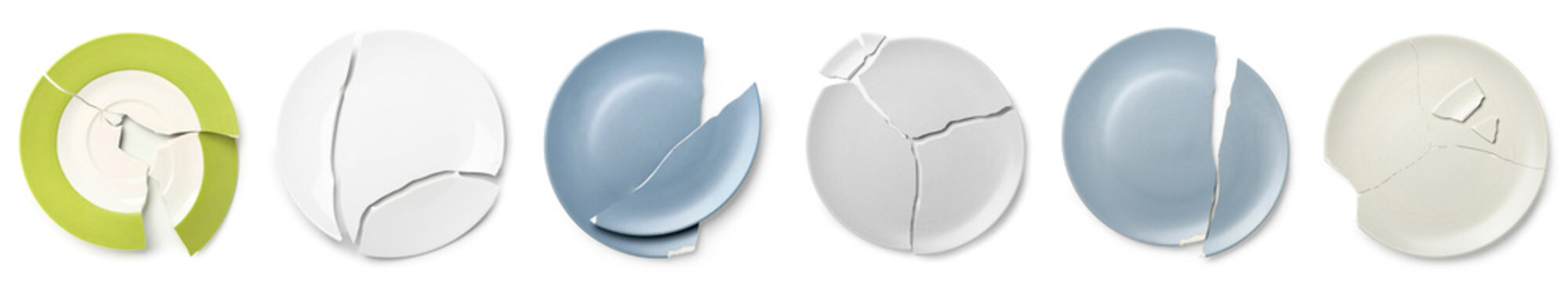 Set of broken ceramic plates on white background