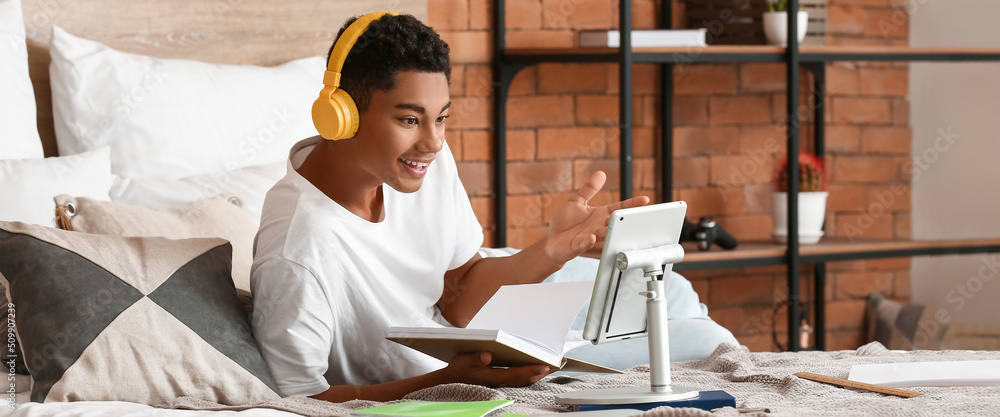 Canvas Prints African-American teenage boy studying online at home