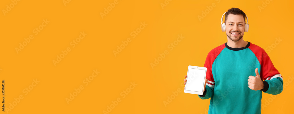 Poster man with tablet computer and headphones on yellow background with space for text