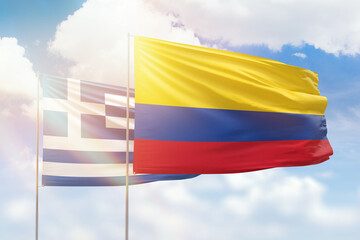 Sunny blue sky and flags of colombia and greece