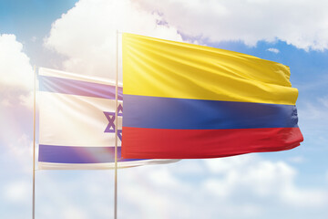 Sunny blue sky and flags of colombia and israel