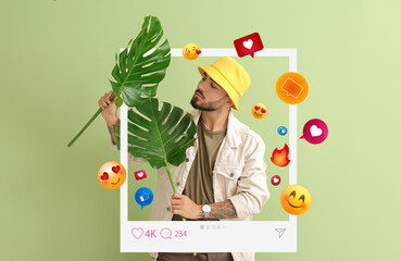 Fashionable young male blogger with tropical leaves on green background