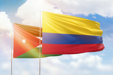 Sunny blue sky and flags of colombia and jordan