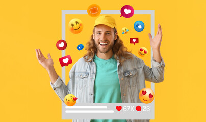 Happy young male blogger on yellow background