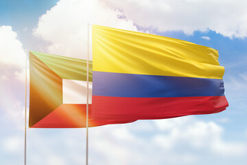 Sunny blue sky and flags of colombia and kuwait