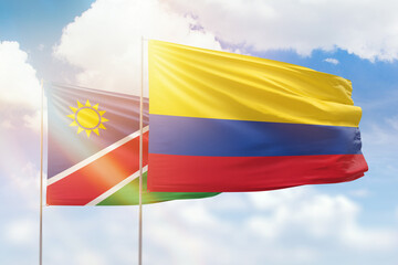 Sunny blue sky and flags of colombia and namibia