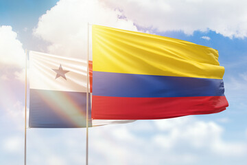 Sunny blue sky and flags of colombia and panama