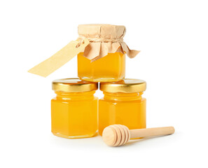Jars with honey and dipper on white background