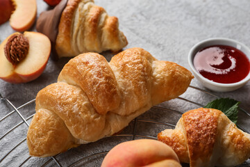 Grid of delicious croissants on light background, closeup