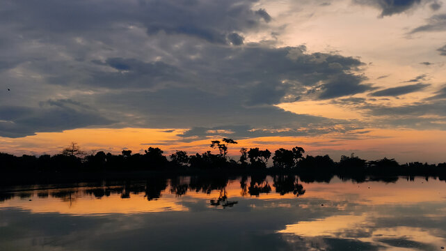sunset over the river. landscape photos of dusk on the river, dusk on the reservoir, photos of the evening sky.  Located in Siman Kediri Reservoir, East Java, Indonesia