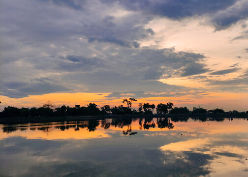 sunset over the lake. landscape photos of dusk on the river, dusk on the reservoir, photos of the evening sky.  Located in Siman Kediri Reservoir, East Java, Indonesia
