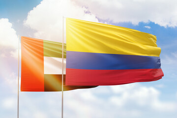 Sunny blue sky and flags of colombia and uae