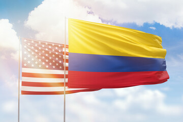 Sunny blue sky and flags of colombia and usa
