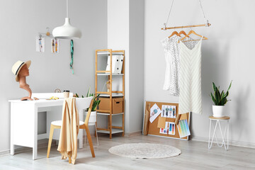 Interior of light modern studio with workplace of clothes stylist