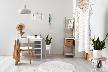 Interior of light modern studio with workplace of clothes stylist