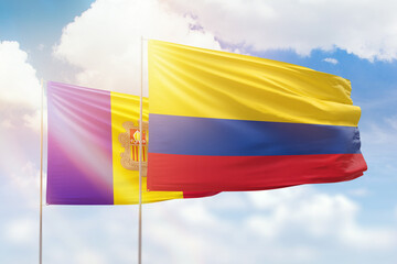 Sunny blue sky and flags of colombia and andorra