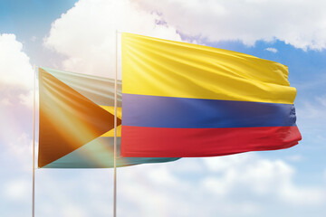 Sunny blue sky and flags of colombia and bahamas