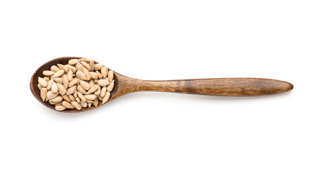 Wooden spoon with peeled sunflower seeds on white background