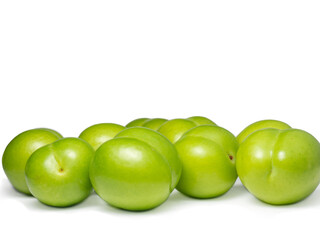 Cherry plum isolate. Fruit background. Preparation of tkemali sauce. Sour, green fruit. One of the varieties of plum. green cherry plum.