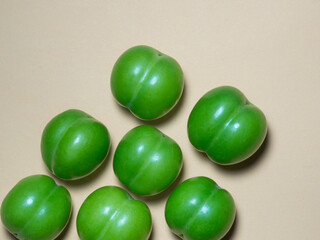 Cherry plum fruits on a beige background. Fruit background. Tkemali sauce ingredient.