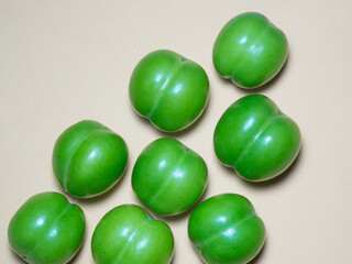 Cherry plum fruits on a beige background. Fruit background. Tkemali sauce ingredient.
