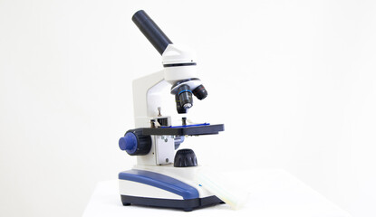 white microscope, laboratory tool on white background