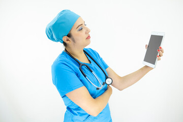 beautiful woman medical assistant, wearing pink uniform and pink surgical cap, stethoscope, using the tablet to display results on white background
