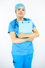 beautiful woman medical, wearing uniform and blue surgical cap, stethoscope on her neck, holding clipboard with results, on white background
