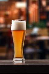 Glass of beer on counter in pub.