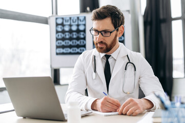 Caucasian smart doctor attentively listens to patient's complaints via video link, while sitting at workplace, writes out a prescription to the patient, prescribes treatment, makes recommendations