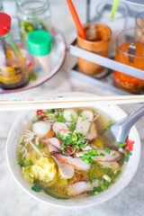 egg noodle soup serve with fish ball and pork