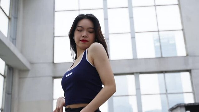 slow motion young asian woman dance on the roof in the city